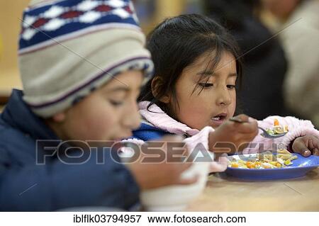 "Children eating in the cafeteria of their school, El Alto, Department of La Paz, Bolivia, South America" View Large Photo Image Stock Photo - "Children eating in the cafeteria of their school, El Alto, Department of La Paz, Bolivia, South America". Fotosearch