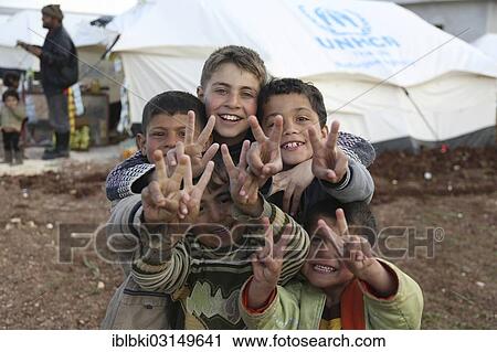 Stock Image - "Children in a camp for Syrian refugees of the civil war near the Turkish border, Bab al-Salameh, Azaz, Aleppo, Syria, Asia". Fotosearch