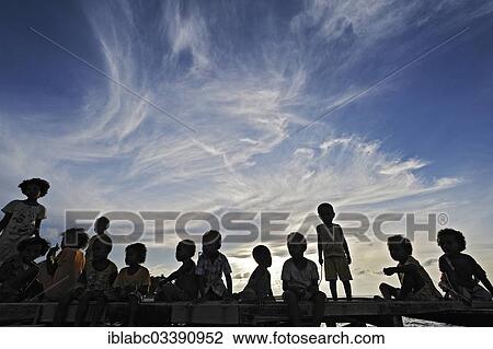 "Children on a jetty, Arborek, Raja Ampat, West Papua, Indonesia, Asia" View Large Photo Image Stock Image - "Children on a jetty, Arborek, Raja Ampat, West Papua, Indonesia, Asia". Fotosearch