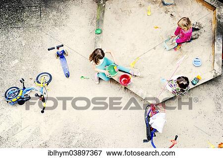 Stock Photo - "Children playing in the sandbox of a backyard, Dusseldorf, Rhineland, North Rhine-Westphalia, Germany, Europe". Fotosearch