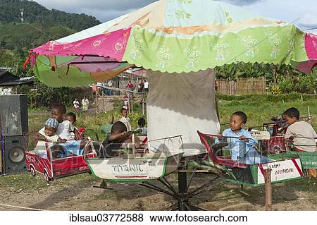 "Children riding on a carousel, self-made children's carousel at a fair, Ranomafana, Madagascar, Africa" View Large Photo Image Stock Photo - "Children riding on a carousel, self-made children's carousel at a fair, Ranomafana, Madagascar, Africa". Fotosearch