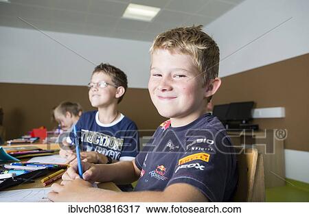 "Children sitting in a primary school class during a drawing lesson, Reith im Alpbachtal, Kufstein district, Tyrol, Austria, Europe" View Large Photo Image Stock Photo - "Children sitting in a primary school class during a drawing lesson, Reith im Alpbachtal, Kufstein district, Tyrol, Austria, Europe". Fotosearch