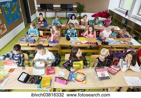 "Children sitting in an elementary school class during a lesson, Reith im Alpbachtal, Kufstein district, Tyrol, Austria, Europe" View Large Photo Image Stock Image - "Children sitting in an elementary school class during a lesson, Reith im Alpbachtal, Kufstein district, Tyrol, Austria, Europe". Fotosearch
