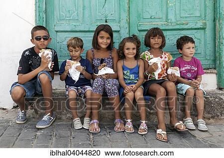 "Children sitting in front of a green door holding food, Teguise, Lanzarote, Canary Islands, Spain, Europe" View Large Photo Image Stock Image - "Children sitting in front of a green door holding food, Teguise, Lanzarote, Canary Islands, Spain, Europe". Fotosearch
