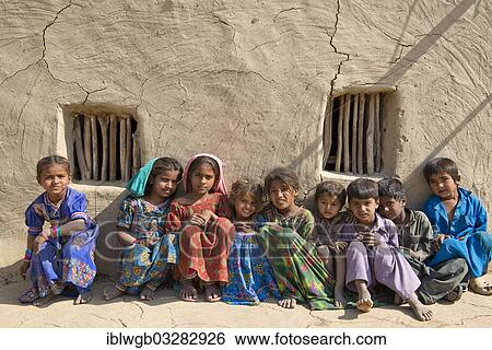 "Children sitting in front of a mudbrick house, Rann of Kutch, Gujarat, India, Asia" View Large Photo Image Stock Photograph - "Children sitting in front of a mudbrick house, Rann of Kutch, Gujarat, India, Asia". Fotosearch