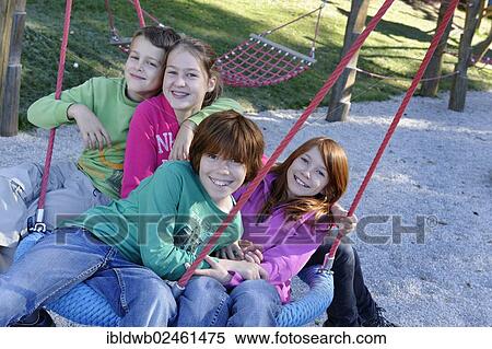 "Children sitting on a swing, Schliersbergalm alp, Schliersee, Upper Bavaria, Bavaria, Germany, Europe" View Large Photo Image Stock Photography - "Children sitting on a swing, Schliersbergalm alp, Schliersee, Upper Bavaria, Bavaria, Germany, Europe". Fotosearch