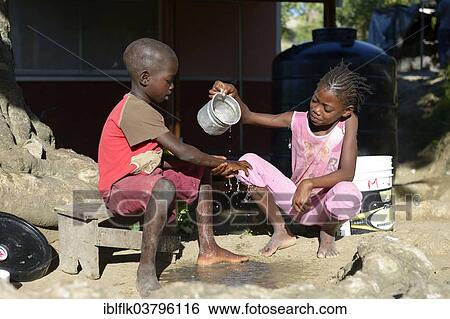 "Children washing their hands, village Tchawa, Leogane, Haiti, North America" View Large Photo Image Stock Photograph - "Children washing their hands, village Tchawa, Leogane, Haiti, North America". Fotosearch