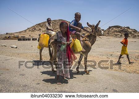 "Children with a donkey on the way to a waterhole, in the lowlands, Eritrea, Africa" View Large Photo Image Stock Image - "Children with a donkey on the way to a waterhole, in the lowlands, Eritrea, Africa". Fotosearch