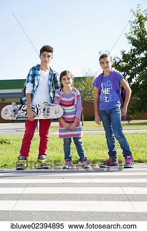 Children with a skateboard and carrying school bags on the way to school View Large Photo Image Stock Photography - Children with a skateboard and carrying school bags on the way to school. Fotosearch
