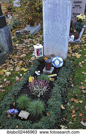 Stock Image - "Child's grave with football on the Ostfriedhof or East Cemetery, Munich, Bavaria, Germany, Europe". Fotosearch