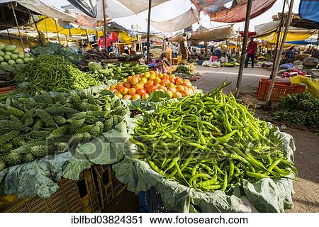 Stock Image - "Chilis, tomatoes and cucumbers for sale at the weekly vegetable market, Nasik, Maharashtra, India, Asia". Fotosearch