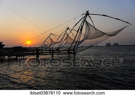 Stock Image - "Chinese fishing nets at sunset, Kochi, Kerala, South India, India, Asia". Fotosearch