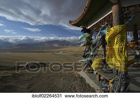 Stock Image - "Chinese Mongolian pavilion adorned with Buddhist prayer flags flying in the wind, grasslands of Bayanbulak, Bayingolin Mongol Autonomous Prefecture, Kuqa, Silk Road, Tianshan Mountains, Tien Shan, Xinjiang, China, Asia". Fotosearch