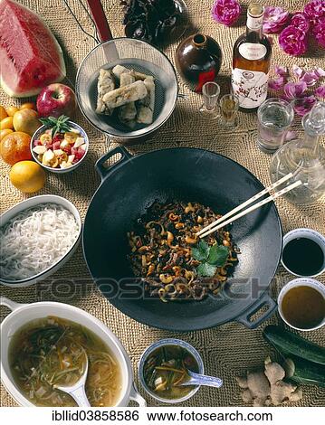 Stock Photograph - "Chinese national cuisine, rice noodles, spring rolls, Chinese noodles, Mu-err mushrooms, Chinese soup, plum wine". Fotosearch