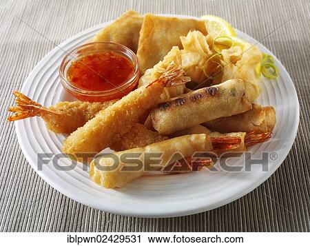 Stock Image - "Chinese starters, deep fried breaded prawns, spring rolls, dim sum, and samosas". Fotosearch