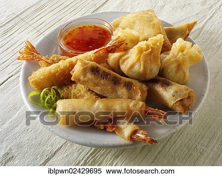 Stock Photography - "Chinese starters, deep fried breaded prawns, spring rolls, dim sum, and samosas". Fotosearch