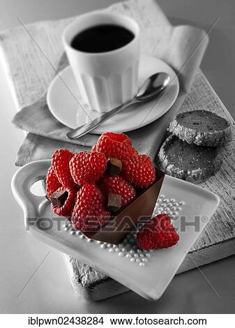 Picture - Chocolate cake filled with chocolate truffle and topped with fresh raspberries. Fotosearch