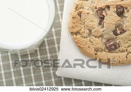 Chocolate chip cookie and a glass of milk View Large Photo Image Stock Photography - Chocolate chip cookie and a glass of milk. Fotosearch