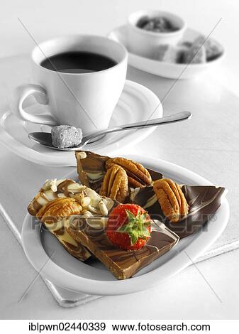 Stock Photo - Chocolate swirl biscuits with nuts and fruit and coffee. Fotosearch