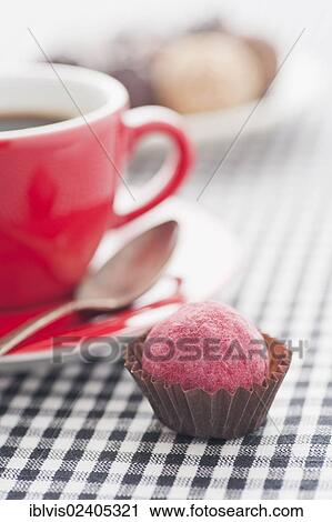 Chocolate truffle beside to a red coffee cup View Large Photo Image Stock Image - Chocolate truffle beside to a red coffee cup. Fotosearch