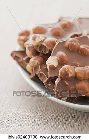Chocolate with hazelnuts View Large Photo Image Stock Photo - Chocolate with hazelnuts. Fotosearch