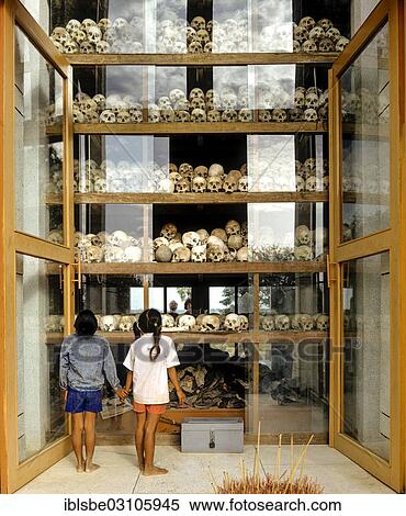 "Choeung Ek, Killing Fields, pagoda for the 17000 victims of the Pol Pot regime, children looking at the skulls, Choeung Ek, Phnom Penh, Phnom Penh Province, Cambodia, Asia" View Large Photo Image Stock Photography - "Choeung Ek, Killing Fields, pagoda for the 17000 victims of the Pol Pot regime, children looking at the skulls, Choeung Ek, Phnom Penh, Phnom Penh Province, Cambodia, Asia". Fotosearch