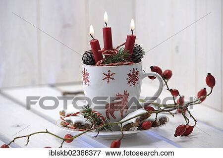 "Christmas ambience with a teacup, burning candles and rose hips" View Large Photo Image Stock Photo - "Christmas ambience with a teacup, burning candles and rose hips". Fotosearch