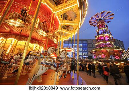 Stock Photo - "Christmas market on Alexanderplatz square with a children's merry-go-round and a Christmas pyramid, Berlin, Germany, Europe". Fotosearch