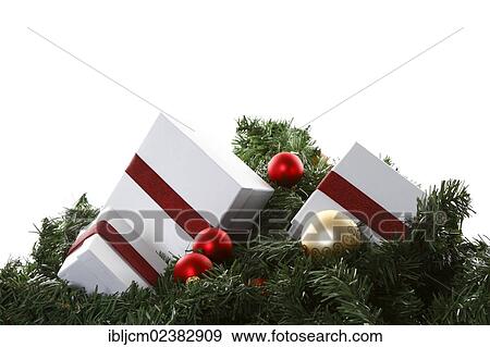 Christmas presents and baubles on artificial fir sprigs View Large Photo Image Stock Photo - Christmas presents and baubles on artificial fir sprigs. Fotosearch