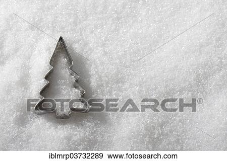 Christmas tree cookie cutter in the snow View Large Photo Image Stock Photo - Christmas tree cookie cutter in the snow. Fotosearch