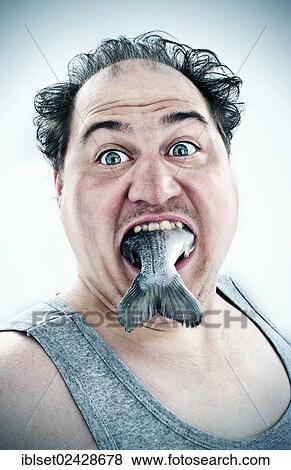 Chubby man with a fish in his mouth View Large Photo Image Stock Photo - Chubby man with a fish in his mouth. Fotosearch