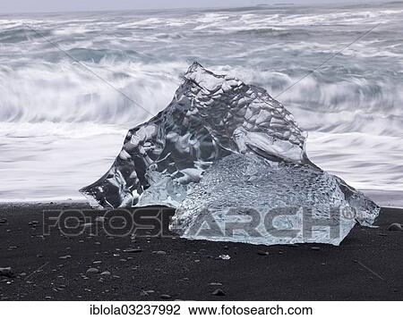 "Chunk of ice lying on the black sandy lava beach on the edge of the Vatnajokull Glacier, Skaftafell National Park, Sudost-Island, Iceland, Europe" View Large Photo Image Stock Image - "Chunk of ice lying on the black sandy lava beach on the edge of the Vatnajokull Glacier, Skaftafell National Park, Sudost-Island, Iceland, Europe". Fotosearch