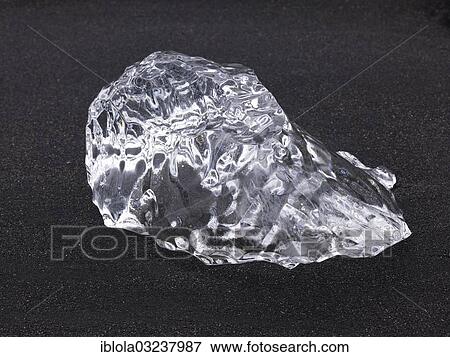 Stock Photo - "Chunk of ice lying on the black sandy lava beach on the edge of the Vatnajokull Glacier, Skaftafell National Park, Sudost-Island, Iceland, Europe". Fotosearch