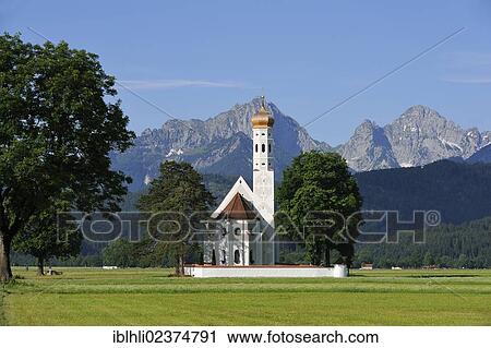 Stock Image - "Church of St. Coloman, Schwangau region, Tannheim Mountains at back, Ostallgaeu district, Allgaeu, Swabia, Bavaria, Germany, Europe". Fotosearch