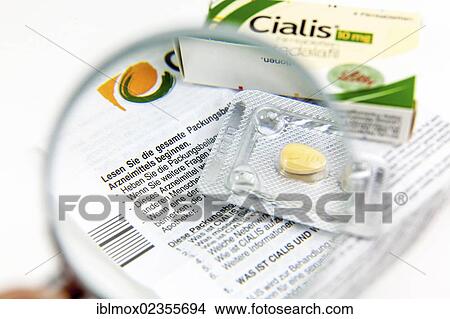 Cialis tablets for increasing virility under a magnifying glass View Large Photo Image Picture - Cialis tablets for increasing virility under a magnifying glass. Fotosearch