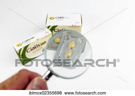 Cialis tablets for increasing virility under a magnifying glass View Large Photo Image Stock Photo - Cialis tablets for increasing virility under a magnifying glass. Fotosearch