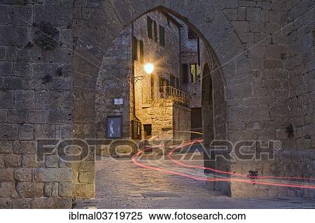 "City gate with the light trace of a passing car, Monticchiello, Val d'Orcia region, Province of Siena, Tuscany, Italy, Europe" View Large Photo Image Stock Photography - "City gate with the light trace of a passing car, Monticchiello, Val d'Orcia region, Province of Siena, Tuscany, Italy, Europe". Fotosearch