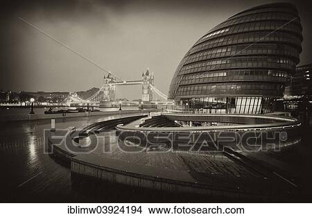 Picture - "City Hall, designed by Norman Foster, Tower Bridge at the back, dusk, London, England, United Kingdom, Europe". Fotosearch