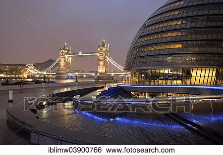 Stock Photograph - "City Hall designed by Sir Norman Foster, Tower Bridge at the back, at dusk, London, England, United Kingdom, Europe". Fotosearch