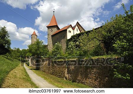 "City wall and lower part of the Epiphany Tower, watchtower, square ashlar masonry construction positioned on a corner from 1372, Green Tower at the rear, early 15th Century, Dinkelsbuhl, Middle Franconia, Bavaria, Germany, Europe" View Large Photo Image Stock Photo - "City wall and lower part of the Epiphany Tower, watchtower, square ashlar masonry construction positioned on a corner from 1372, Green Tower at the rear, early 15th Century, Dinkelsbuhl, Middle Franconia, Bavaria, Germany, Europe". Fotosearch