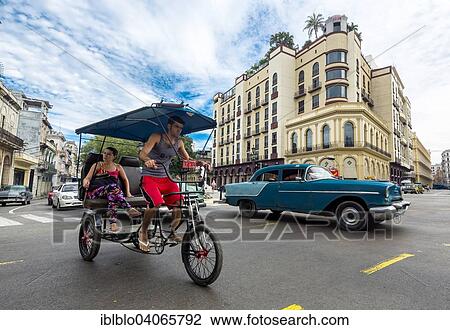 "Classic car and bike rickshaw on the road junction at the Hotel Telegrafo, Havana, Cuba, North America" View Large Photo Image Stock Image - "Classic car and bike rickshaw on the road junction at the Hotel Telegrafo, Havana, Cuba, North America". Fotosearch