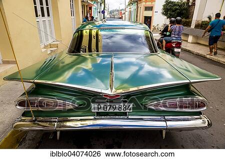 Stock Photograph - "Classic car, road cruiser, green Impala, Santa Clara, Cuba, North America". Fotosearch