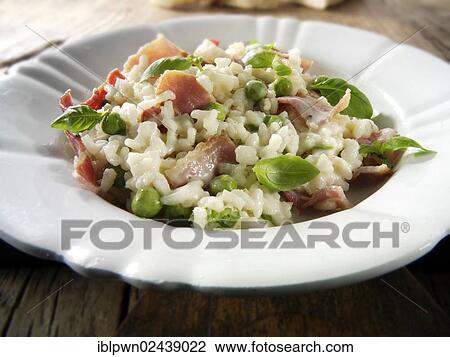 Stock Image - "Classic risotto with fresh peas, bacon and mint". Fotosearch
