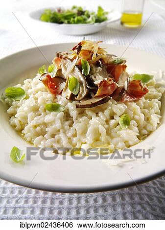 Classic risotto with wild mushrooms and bacon View Large Photo Image Stock Photograph - Classic risotto with wild mushrooms and bacon. Fotosearch