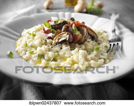 Classic risotto with wild porcini mushrooms and bacon View Large Photo Image Stock Photo - Classic risotto with wild porcini mushrooms and bacon. Fotosearch