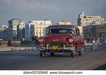 Stock Photo - "Classic U. S. road cruiser driving along the Malecon, Havana's seaside promenade, Havana, La Habanna, Cuba, North America". Fotosearch