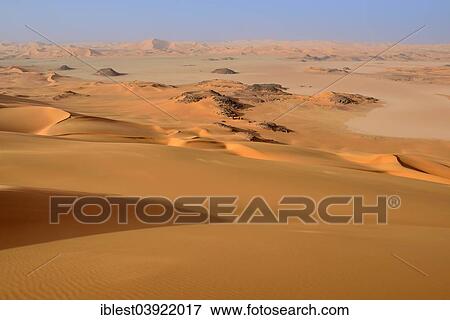 "Claypan or playa and sand dunes of Oued In Djerane, Tadrart region, Tassili n'Ajjer National Park, Sahara desert, Algeria, Africa" View Large Photo Image Stock Photo - "Claypan or playa and sand dunes of Oued In Djerane, Tadrart region, Tassili n'Ajjer National Park, Sahara desert, Algeria, Africa". Fotosearch
