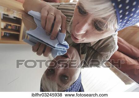"Cleaning lady reflected in the table top she is cleaning, Germany, Europe" View Large Photo Image Stock Photo - "Cleaning lady reflected in the table top she is cleaning, Germany, Europe". Fotosearch