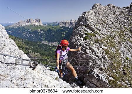 "Climber ascending on the Via ferrata dei Finanzieri to the top of Colac, Sasso Lungo and Sasso Piatto in the back, Pordoijoch and Sella, Val di Fassa, Dolomites, Trentino, Italy, Europe" View Large Photo Image Stock Image - "Climber ascending on the Via ferrata dei Finanzieri to the top of Colac, Sasso Lungo and Sasso Piatto in the back, Pordoijoch and Sella, Val di Fassa, Dolomites, Trentino, Italy, Europe". Fotosearch