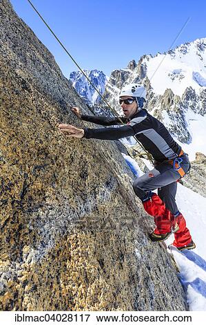 "Climber climbing on a rock wall, alpine climb, Alps, below the summit, Petite Forch, Canton of Valais, Switzerland, Europe" View Large Photo Image Stock Photo - "Climber climbing on a rock wall, alpine climb, Alps, below the summit, Petite Forch, Canton of Valais, Switzerland, Europe". Fotosearch